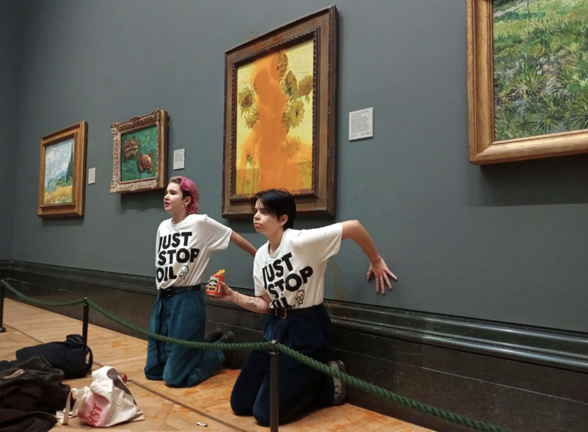 Two Just Stop Oil protesters in front of Van Gogh’s “Sunflowers” after throwing tomato soup over the painting and gluing their hands to the wall. The painting could have been permanently damaged, but luckily it was cleaned up and restored quickly.